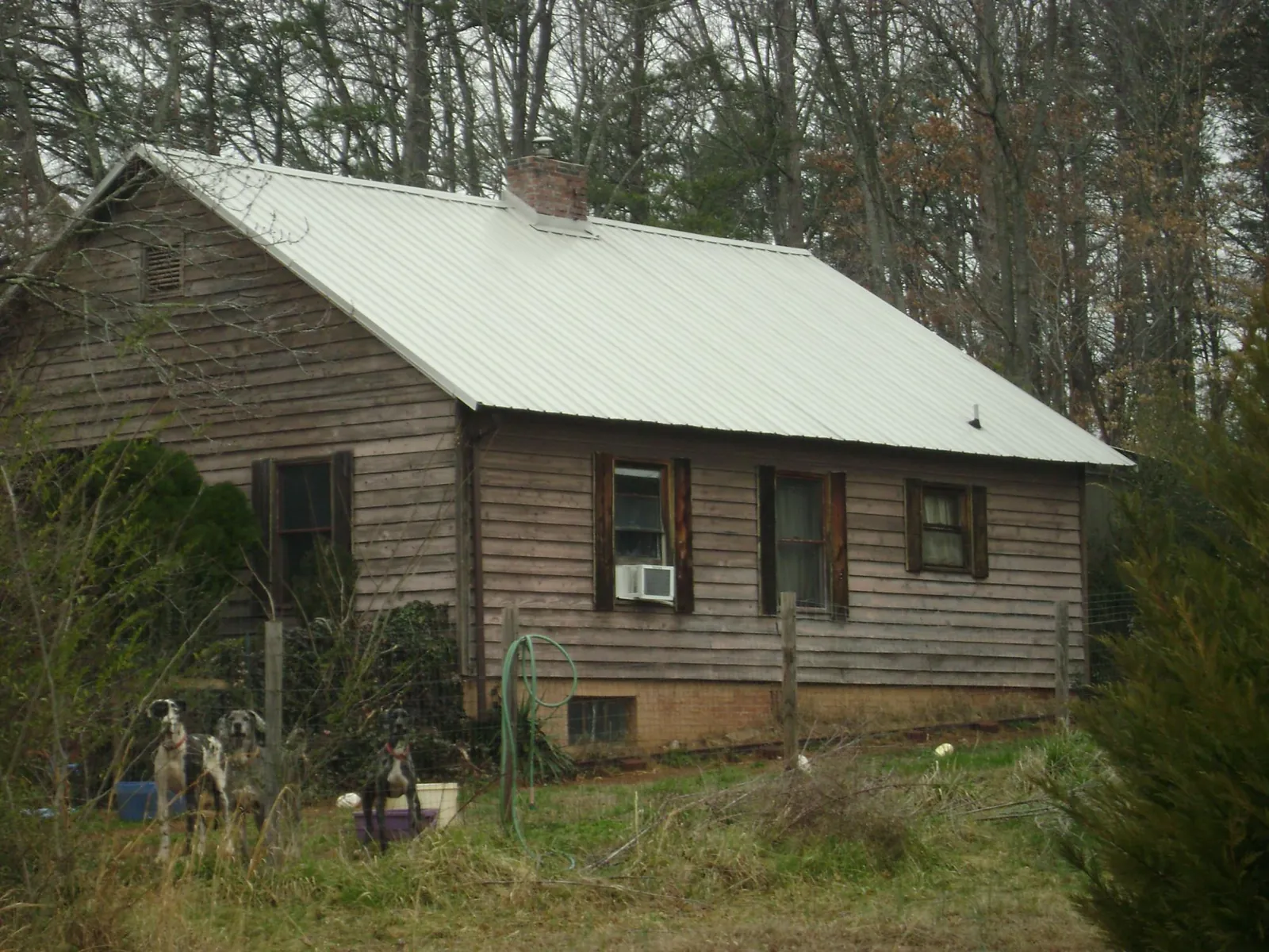 White metal roof on an old wood sided farmhouse, from a Asphalt Shingle Roof Repair job in Camak